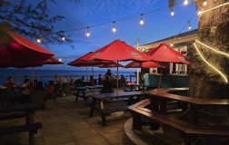 Outdoor dining at Blakey’s Bar and Restaurant overlooking the ocean on the Hastings Boardwalk in Barbados